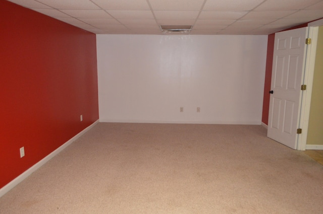 basement with carpet floors and a paneled ceiling