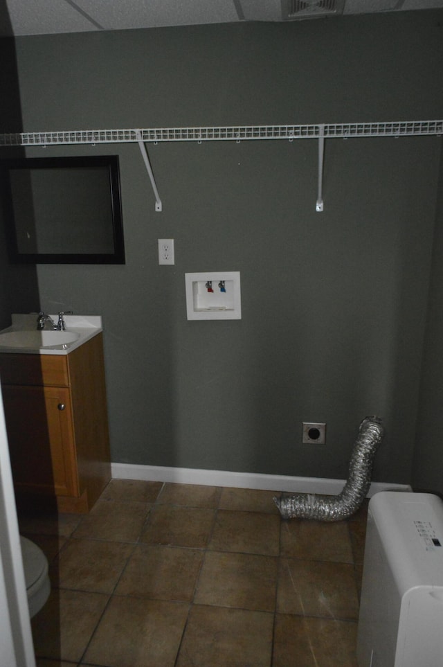 laundry room with hookup for a washing machine, electric dryer hookup, sink, and tile patterned flooring