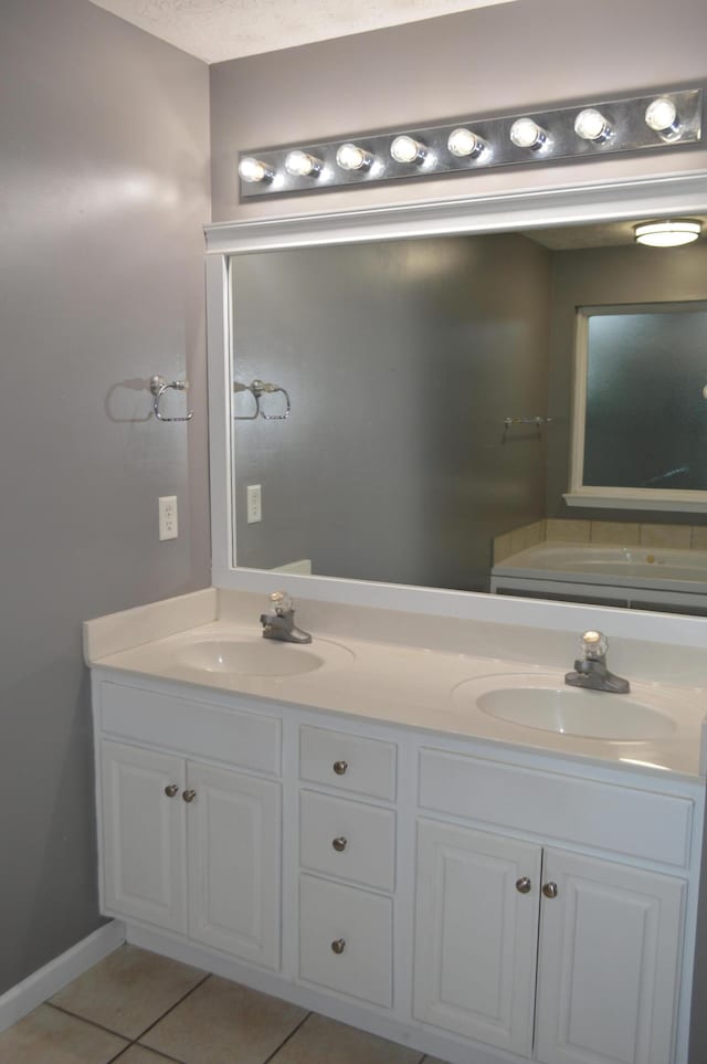 bathroom with vanity, a textured ceiling, and tile patterned floors