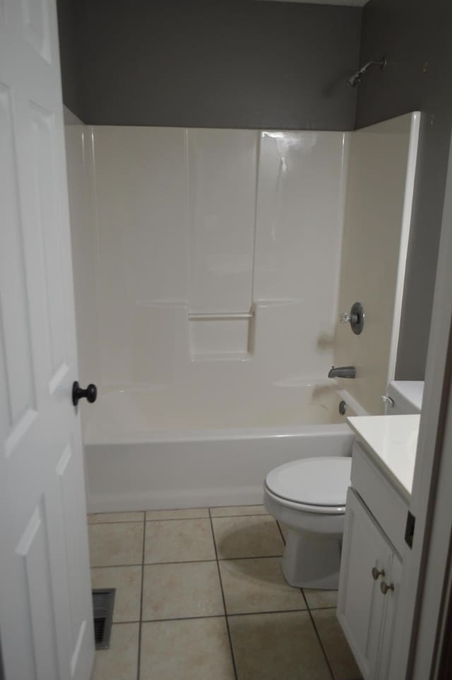 full bathroom featuring vanity, washtub / shower combination, toilet, and tile patterned floors