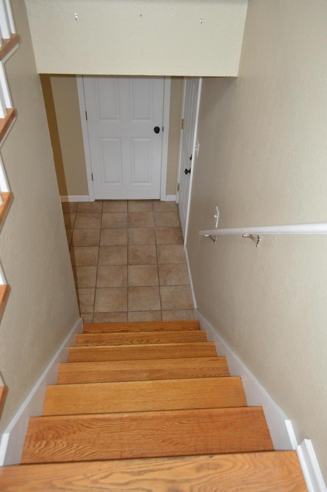 stairway featuring tile patterned floors