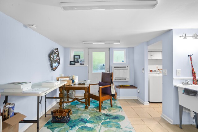 office featuring heating unit, light tile patterned floors, and washer / clothes dryer