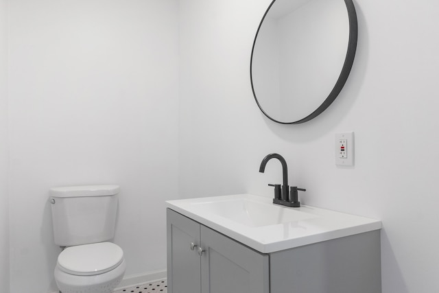 bathroom with vanity, toilet, and tile patterned flooring