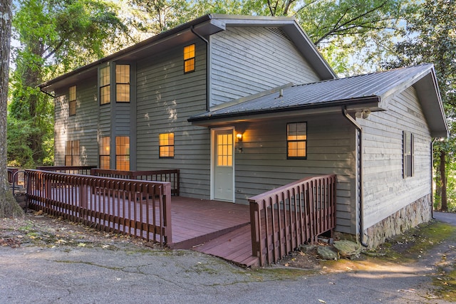 back of property featuring a wooden deck