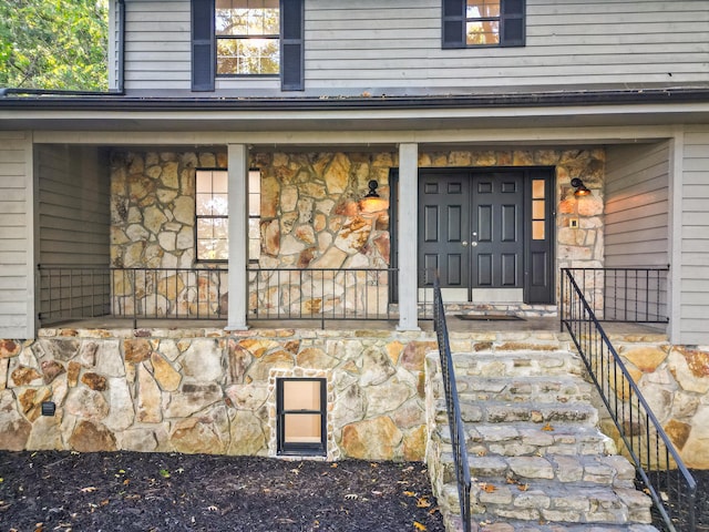 view of exterior entry with covered porch