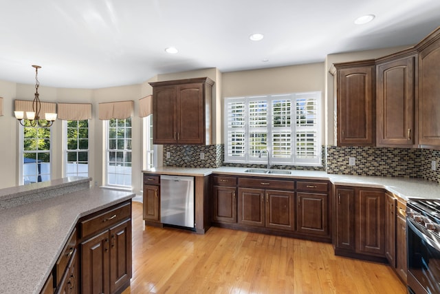 kitchen with sink, light wood-type flooring, plenty of natural light, and stainless steel appliances