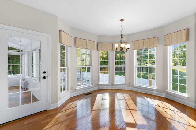 interior space with an inviting chandelier and a healthy amount of sunlight