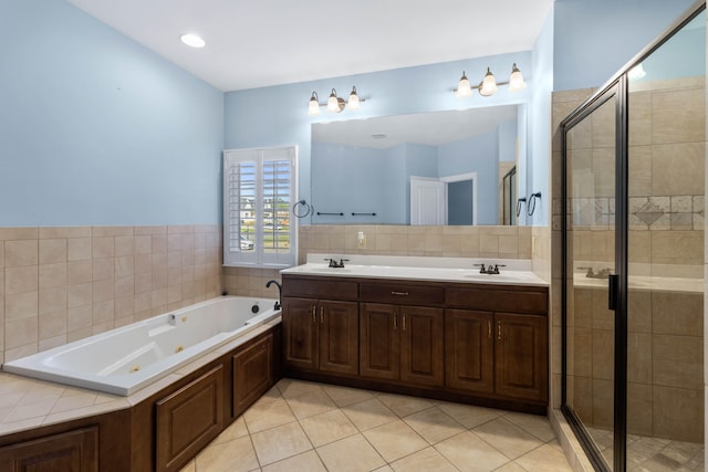 bathroom with vanity, tile patterned flooring, and plus walk in shower