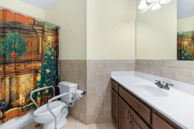 bathroom featuring vanity, toilet, tile patterned floors, and tile walls