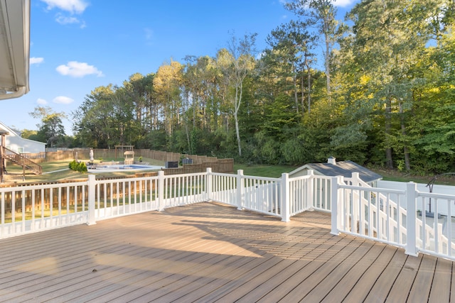 wooden terrace featuring a swimming pool