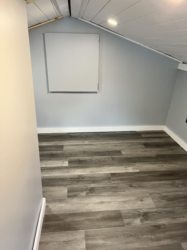 interior space with vaulted ceiling with beams, dark hardwood / wood-style flooring, and wooden ceiling