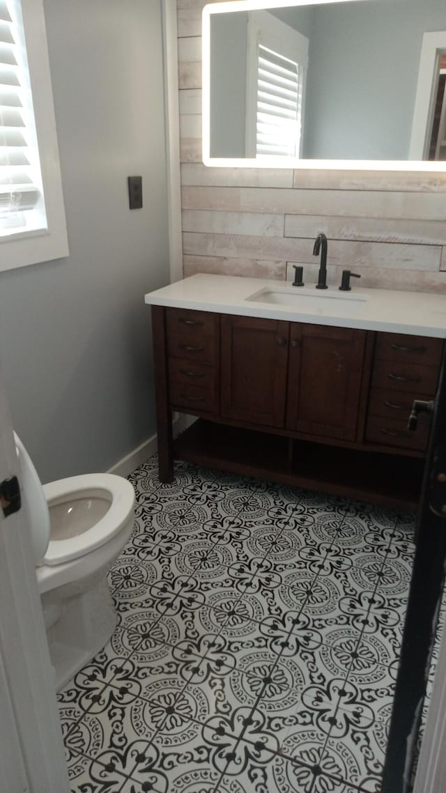 bathroom featuring tile patterned floors, vanity, and toilet