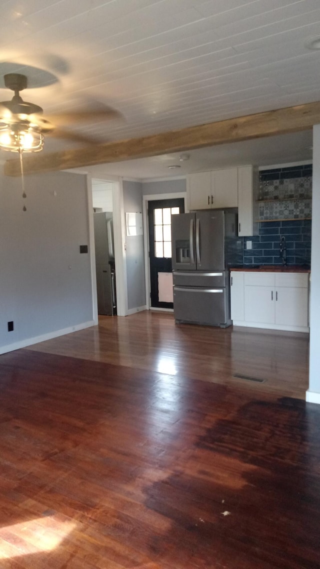 kitchen featuring stainless steel fridge, dark hardwood / wood-style flooring, tasteful backsplash, ceiling fan, and white cabinetry