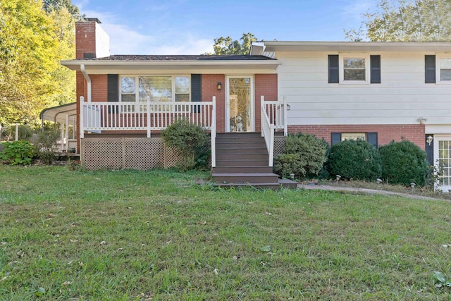 split level home featuring a wooden deck and a front lawn