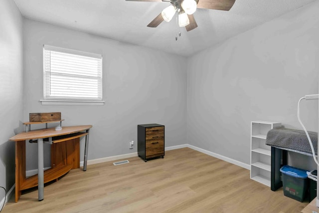 misc room with ceiling fan and light hardwood / wood-style flooring