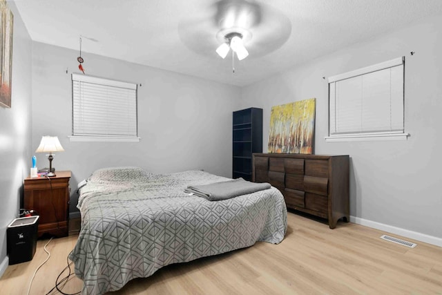 bedroom with light hardwood / wood-style flooring and ceiling fan