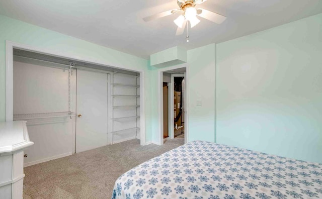 carpeted bedroom featuring a closet and ceiling fan