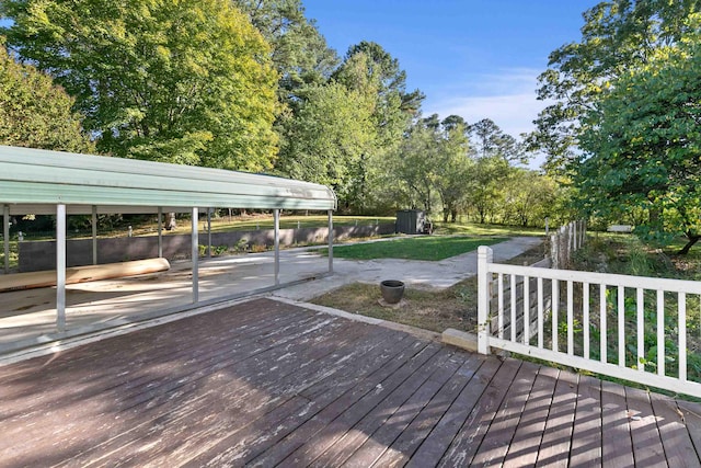 wooden terrace featuring a carport