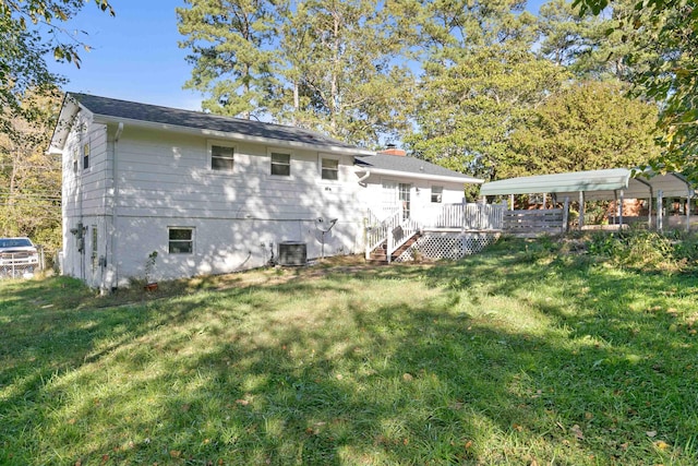 rear view of property featuring a yard, central AC, and a deck