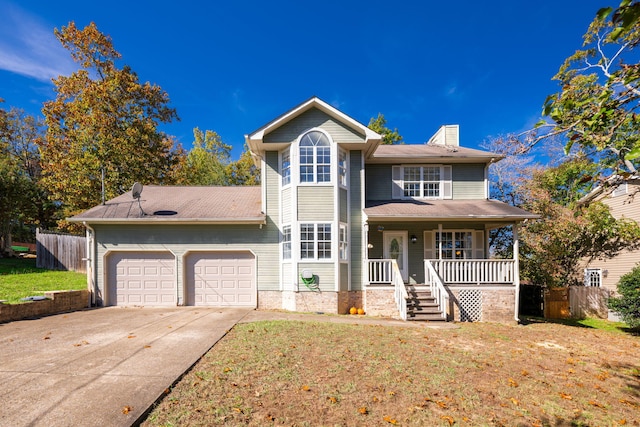 view of front property with a garage, a front yard, and covered porch