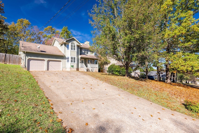 front facade with a garage, a front yard, and a porch