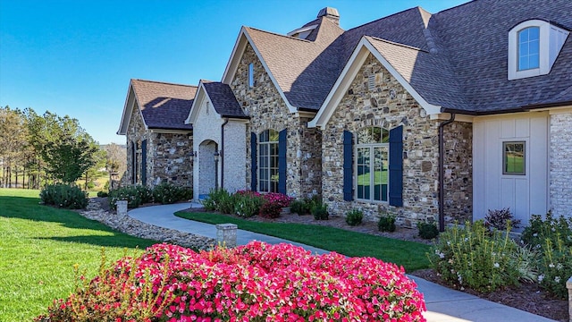 french country inspired facade featuring a front yard