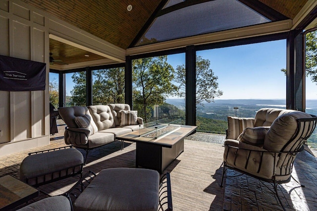 sunroom with wood ceiling, a wealth of natural light, and vaulted ceiling