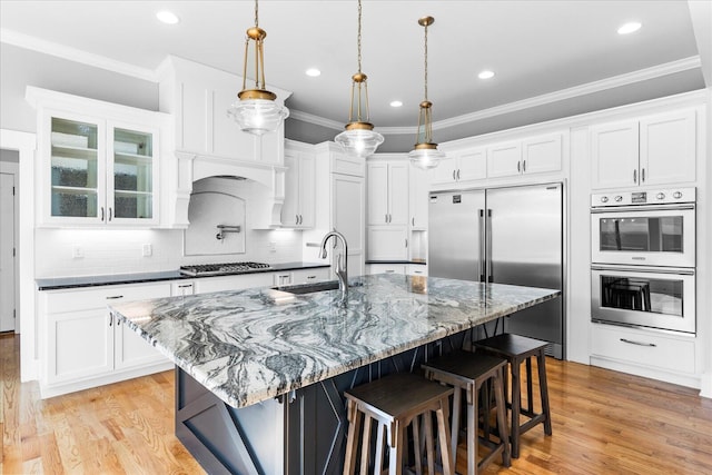 kitchen featuring white cabinetry, light wood-type flooring, sink, and stainless steel appliances