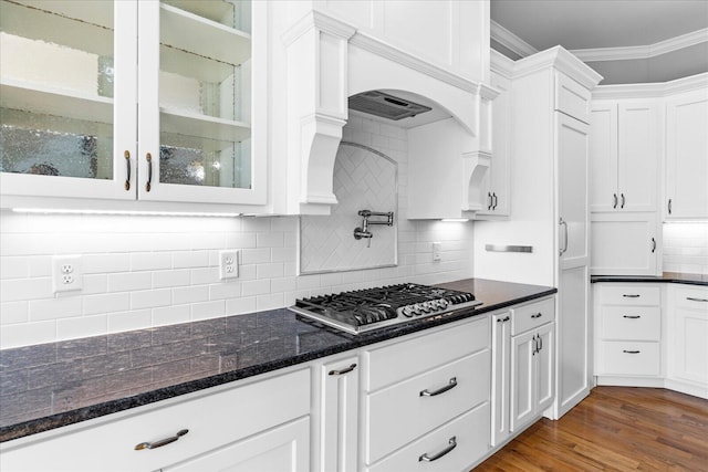 kitchen with tasteful backsplash, ornamental molding, dark hardwood / wood-style floors, white cabinetry, and stainless steel gas stovetop