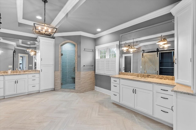 bathroom featuring parquet flooring, vanity, an enclosed shower, and crown molding