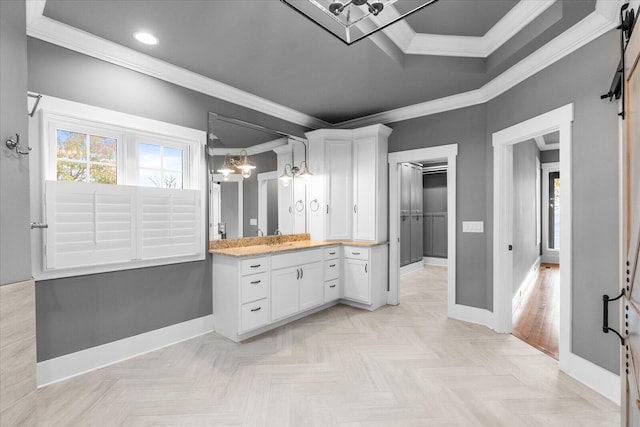 bathroom with parquet floors, vanity, and ornamental molding