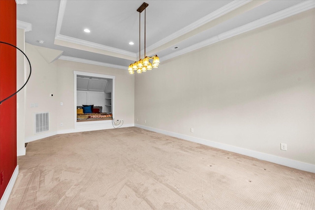 interior space with a tray ceiling, light carpet, and crown molding