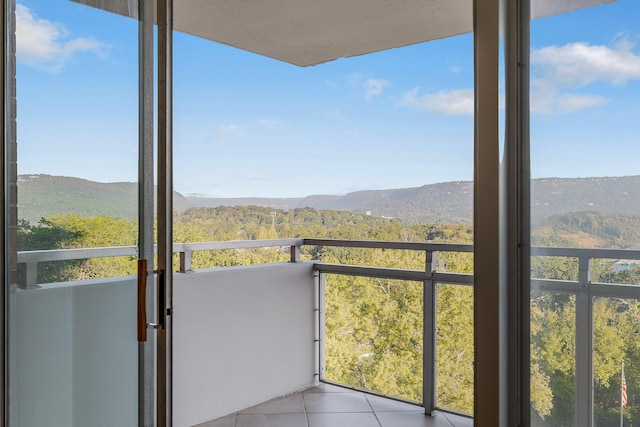 interior space with a mountain view and light tile patterned floors