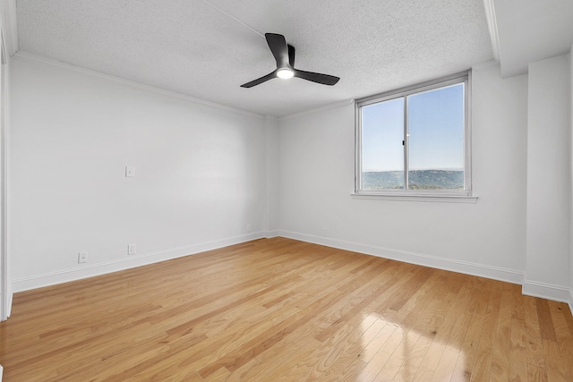 unfurnished room featuring ornamental molding, a textured ceiling, light wood-type flooring, and ceiling fan