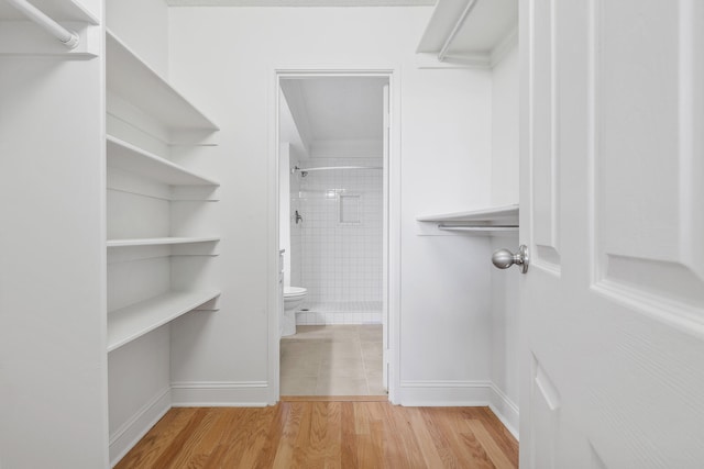 spacious closet with light hardwood / wood-style floors