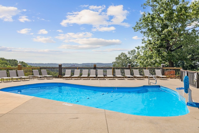 view of pool featuring a mountain view and a patio