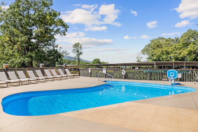 view of pool featuring a patio and a mountain view