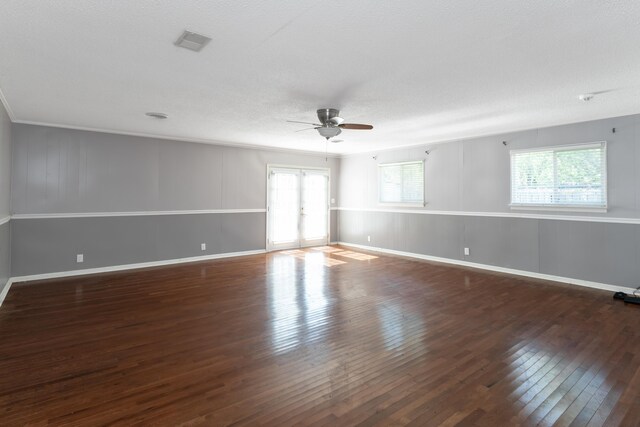 empty room with french doors, dark hardwood / wood-style floors, a textured ceiling, and ceiling fan