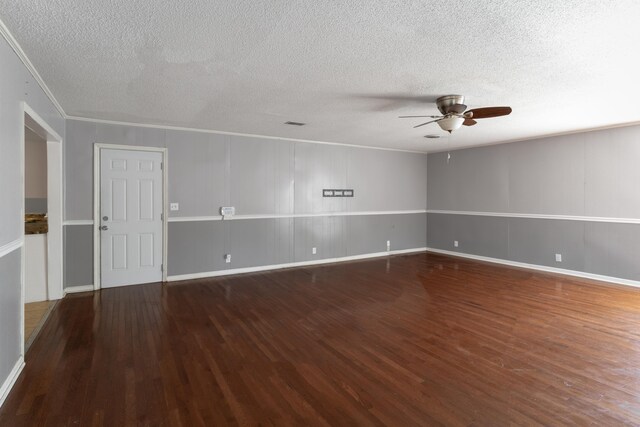 empty room featuring ceiling fan, wood-type flooring, a textured ceiling, and ornamental molding