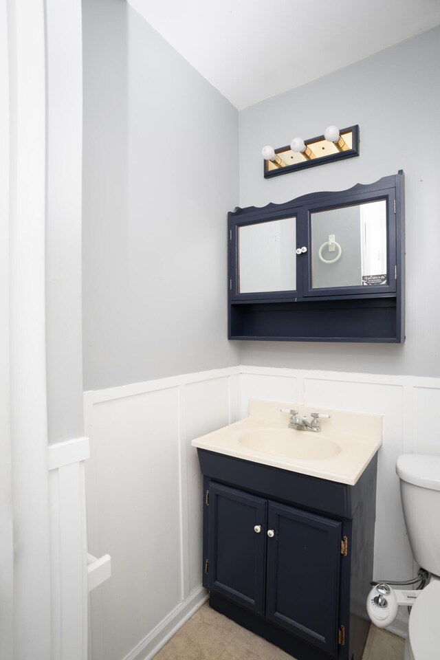 bathroom featuring toilet and vanity