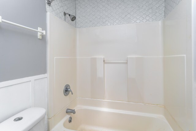 bathroom featuring toilet and shower / washtub combination