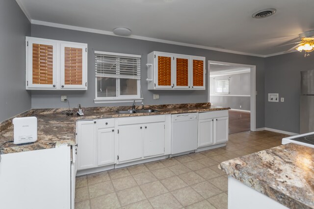 kitchen featuring white dishwasher, sink, crown molding, white cabinets, and ceiling fan