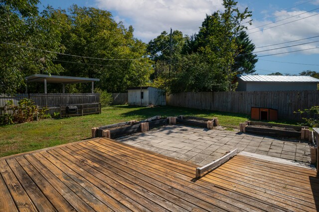 deck with a shed and a lawn