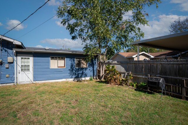 back of house featuring a lawn