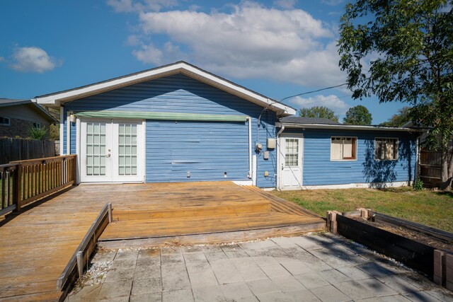 ranch-style home featuring french doors and a deck