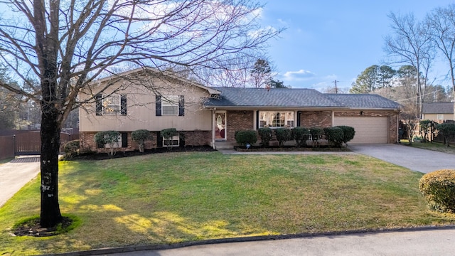 tri-level home with a garage and a front lawn