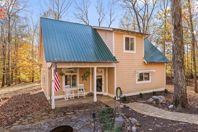 rear view of house featuring a porch