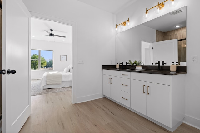 bathroom featuring vanity, wood-type flooring, and ceiling fan