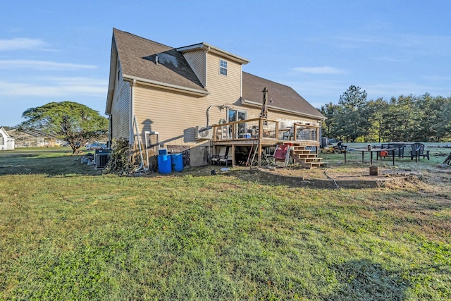 rear view of property with central AC, a yard, and a deck