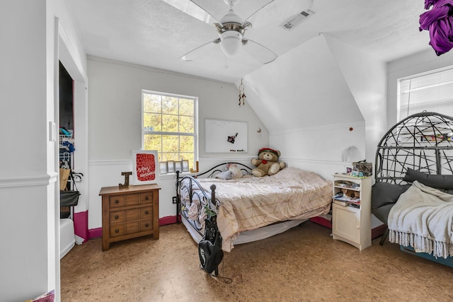 bedroom with ceiling fan, a textured ceiling, and lofted ceiling